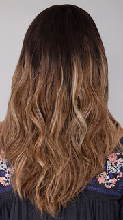 Roxie wearing BALAYAGE BEAUTY by RAQUEL WELCH in RL4/15OM | Dark brown blended roots that transition into a natural blonde ombré from midlength to the ends