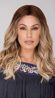 Roxie wearing BALAYAGE BEAUTY by RAQUEL WELCH in RL8/24OM | Medium brown blended roots that transition into a golden blonde ombré from midlength to the ends