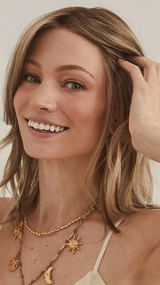 Model is wearing ALICIA by RENE OF PARIS in color CHAMPAGNE SUNSET | Dark/medium multi-tonal blond with textured honey, ash, and golden hues and chocolate brown roots