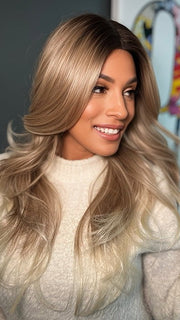 Roxie wearing ALLURE WAVEZ by RENE OF PARIS in  MELTED-MARSHMALLOW | Subtly Warm Dark Sandy Blonde Blend with Medium Brown Roots and Light Ash Blonde Tips and Highlights