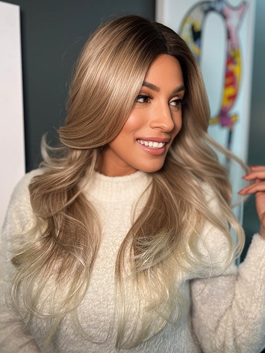 Roxie wearing ALLURE WAVEZ by RENE OF PARIS in  MELTED-MARSHMALLOW | Subtly Warm Dark Sandy Blonde Blend with Medium Brown Roots and Light Ash Blonde Tips and Highlights