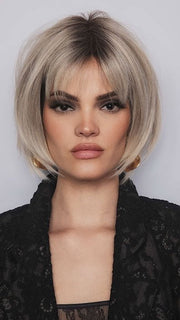 Model is wearing ARIA by RENE OF PARIS in color BILLIONAIRE BLOND | A chic, sophisticated shade with a rich mocha root melting into beige, ash, and cream blond tones. Face-framing cream and white blond highlights add a refined, upscale finish.
