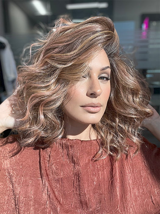 Model is wearing AVALON by ESTETICA in color CINDER HEAT | Reddish brown base blended with smoked copper with soft amber highlights and chestnut brown roots.
