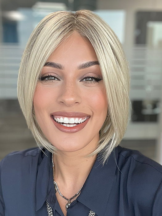 Model is wearing AYUMI by NORIKO in color Light Ash Blond R | Cream Ash Blonde with ash brown and white-grey roots that blend into a variety of ash blonde tones, including ash pearl blonde, creamy ivory, and pale cream