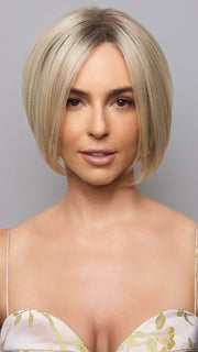Model is wearing AYUMI by NORIKO in color Light Ash Blond R | Cream Ash Blonde with ash brown and white-grey roots that blend into a variety of ash blonde tones, including ash pearl blonde, creamy ivory, and pale cream