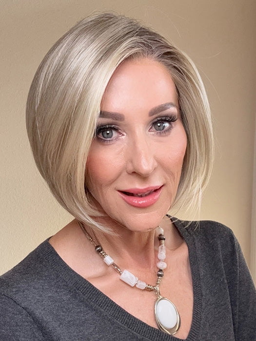 Eileen @crazywiglady is wearing AYUMI by NORIKO in color NM LIGHT ASH BLOND-R | This stunning cream ash blonde features natural-looking ash brown and white-grey roots that blend seamlessly into a variety of ash blonde tones. Woven with ash pearl blonde, creamy ivory, and pale creams, this fashion-forward shade delivers a sophisticated, multi-tonal finish for an elegant ash blonde look.