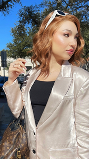 Maha wearing SIMMER ELITE by RAQUEL WELCH WIGS in color RL29/33SS ICED PUMPKIN SPICE | Strawberry Blonde Shaded with Dark Red-Brown