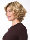 Model is wearing BIANCA by ENVY in color SPARKLING-CHAMPAGNE | Medium Brown roots with overall Strawberry Blonde base and soft Golden Blonde highlights