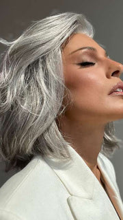 Model is wearing SAGE by ESTETICA in color R51LF60 | Off Black with 75% Grey Lightening to Gold Blonde Mix in Front