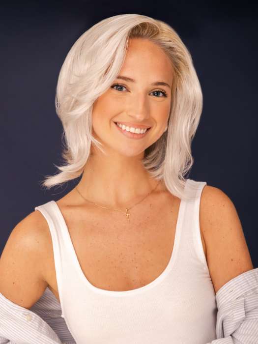 Model is wearing SHEENA by RENE OF PARIS in color GHOST-BLONDE-R | Medium neutral blond roots fade into a pearl cream blond shade with platinum blond undertones.