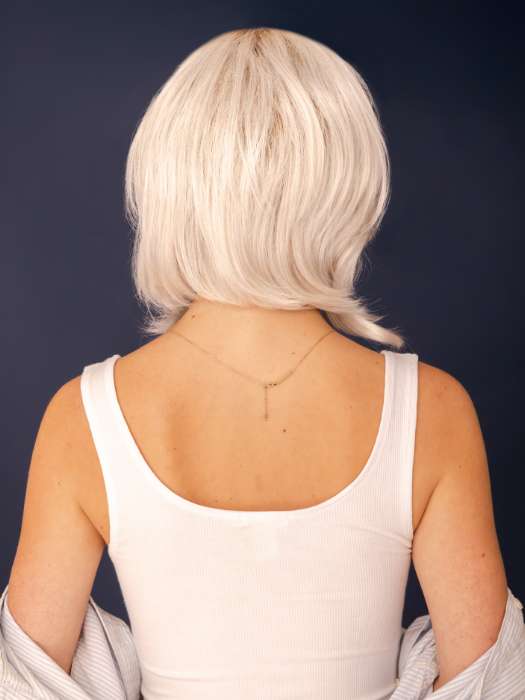 Model is wearing SHEENA by RENE OF PARIS in color GHOST-BLONDE-R | Medium neutral blond roots fade into a pearl cream blond shade with platinum blond undertones.