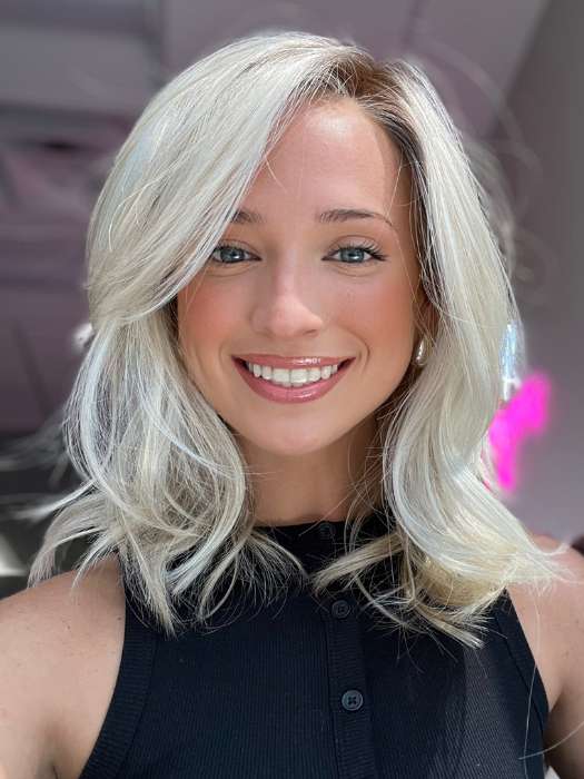 Model is wearing DAZZLING WAVEZ by RENE OF PARIS in color MILKY OPAL R | A Blend of Creamy Blonde and White Blonde Rooted with Warm Brown