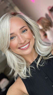 Model is wearing DAZZLING WAVEZ by RENE OF PARIS in color MILKY OPAL R | A Blend of Creamy Blonde and White Blonde Rooted with Warm Brown
