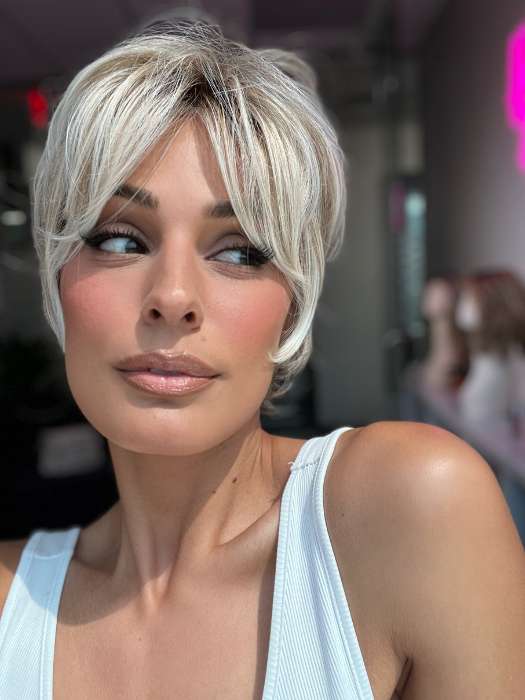 Model is wearing CURATED CUT by RAQUEL WELCH in color RL19/23SS SHADED BISCUIT | Light Ash Blonde Evenly Blended with Cool Platinum Blonde with Dark Roots