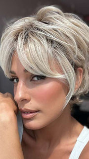 Model is wearing CURATED CUT by RAQUEL WELCH in color RL19/23SS SHADED BISCUIT | Light Ash Blonde Evenly Blended with Cool Platinum Blonde with Dark Roots