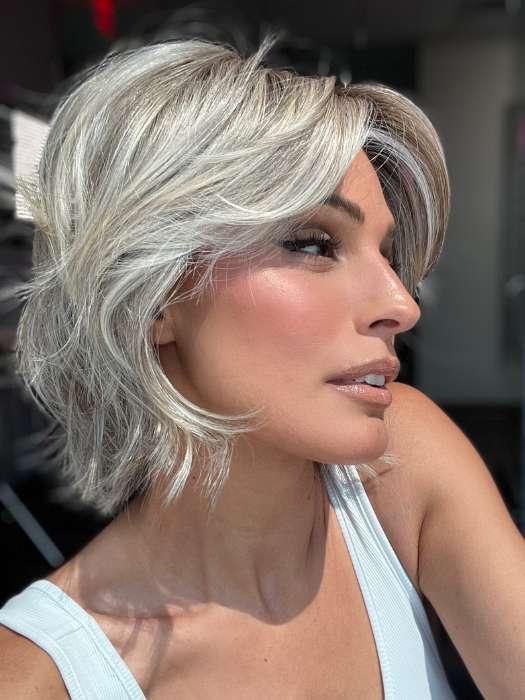 Model is wearing MAIN CHARACTER by RAQUEL WELCH in color RL17/23SS ICED LATTE MACCHIATO | Honey Blonde shaded with Cool Blonde and Dark Roots