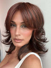 Model is wearing SPECTACULAR SHAG by TressAllure in color 10/130R | Bright Red with Medium Brown Roots