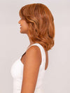 Model is wearing ON MY WAY by RAQUEL WELCH in color RL31/29 FIERY COPPER | Medium Light Auburn Evenly Blended with Ginger Blonde