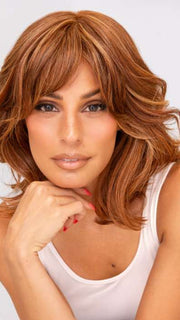 Model is wearing ON MY WAY by RAQUEL WELCH in color RL31/29 FIERY COPPER | Medium Light Auburn Evenly Blended with Ginger Blonde