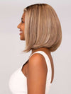 Model is wearing ALWAYS TRENDING by RAQUEL WELCH in color SS12/22 SHADED CAPPUCCINO | Light Golden Brown Evenly Blended with Cool Platinum Blonde Highlights with Dark Roots