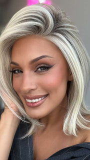 Model is wearing HAUTE by JON RENAU in color 101/88/27S8 CATALINA BLONDE | Pale blonde with Pure White Natural Violet halo highlights, shaded medium brown