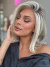 Model is wearing HAUTE by JON RENAU in color 101/88/27S8 CATALINA BLONDE | Pale blonde with Pure White Natural Violet halo highlights, shaded medium brown