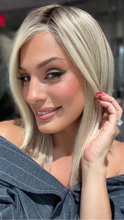 Model is wearing CARRIE by JON RENAU in color 101/88/27S8 CATALINA BLONDE | Pale blonde with Pure White Natural Violet halo highlights, shaded medium brown