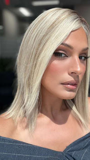 Model is wearing CARRIE by JON RENAU in color 101/88/27S8 CATALINA BLONDE | Pale blonde with Pure White Natural Violet halo highlights, shaded medium brown