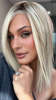 Model is wearing CARRIE by JON RENAU in color 101/88/27S8 CATALINA BLONDE | Pale blonde with Pure White Natural Violet halo highlights, shaded medium brown