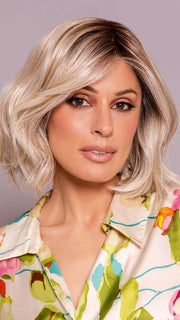 Model is wearing MIRA by AMORE in color SEA SALT BLOND R | A perfect mixture of cool, icy-blond and warm-dark blond. The rich brown root tone enhances the modern appearance.    