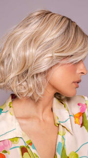 Model is wearing MIRA by AMORE in color SEA SALT BLOND R | A perfect mixture of cool, icy-blond and warm-dark blond. The rich brown root tone enhances the modern appearance.    