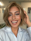 Roxie is wearing CLOVER by ESTETICA in color R12/26CH | Light Brown with Chunky Golden Blonde Highlights