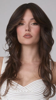 Model is wearing MEDIUM WAVY TP MONO by AMORE in color SPICED MOCHA R | A dark-brown base with perfectly placed warm-medium brown and medium reddish-brown highlights. The root tone adds a natural shadowed effect.