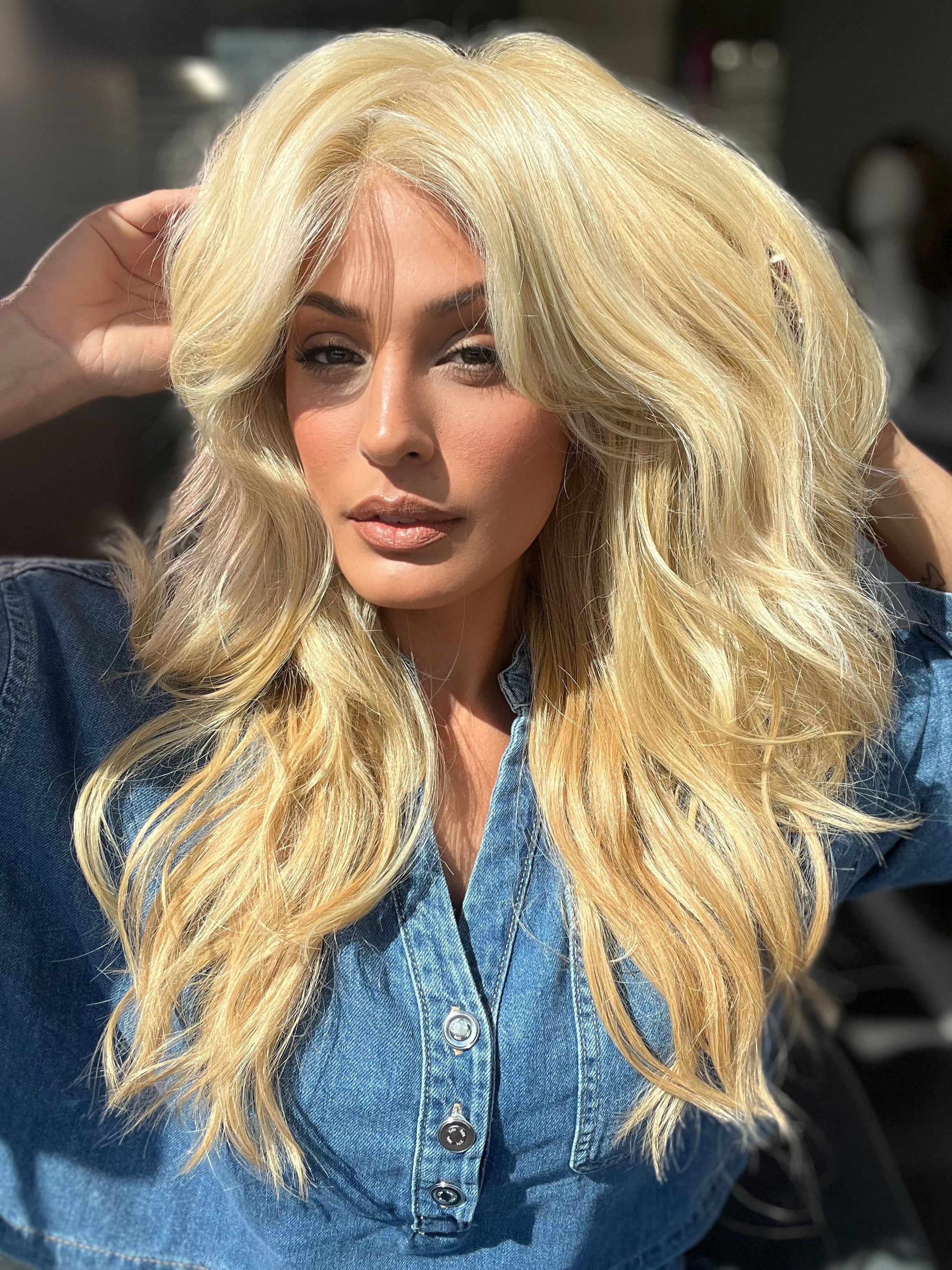 Roxie is wearing California Beach Waves by TressAllure in shade 223/23C | Light Golden Blonde