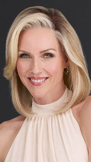 Model is wearing CARRIE by JON RENAU in color 101/88/27S8 CATALINA BLONDE | Pale blonde with Pure White Natural Violet halo highlights, shaded medium brown
