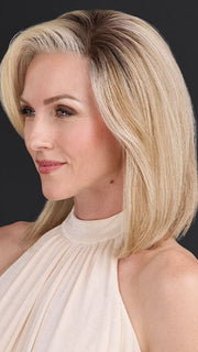 Model is wearing CARRIE by JON RENAU in color 101/88/27S8 CATALINA BLONDE | Pale blonde with Pure White Natural Violet halo highlights, shaded medium brown