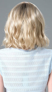 Model is wearing Charlotte Large by ENVY in color SILKY BEIGE |  Light Platinum Blonde with Dark Brown Roots