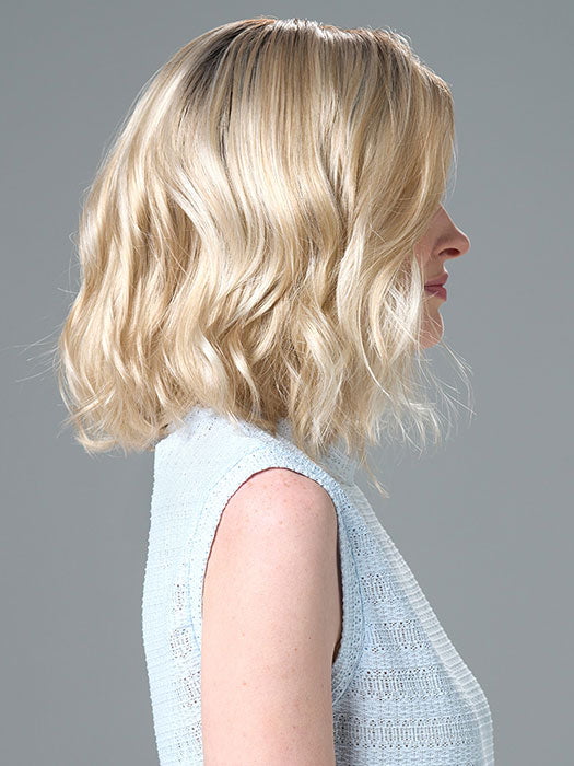 Model is wearing Charlotte Petite by ENVY in color SILKY BEIGE |  Light Platinum Blonde with Dark Brown Roots