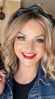 Sandy @i_be_wiggin wearing CHARLOTTE by ENVY BY ALAN EATON in color SAHARA BLONDE | Softer Dark Blonde with Light Golden Blonde, and features Chestnut Roots