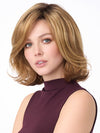 Model is wearing CHLOE by ENVY in color GOLDEN NUTMEG | Medium Brown roots with overall Warm Cinnamon base and Golden Blonde highlights
