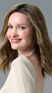 Model is wearing COREY by ENVY in HONEY BREEZE | A blend of Cool, Honey Blonde and Multi-Dimensional Medium Brown with Darker Brown Roots
