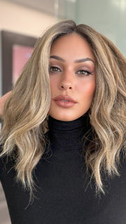 Model is wearing COREY by ENVY in color HONEY BREEZE | A blend of Cool, Honey Blonde and Multi-Dimensional Medium Brown with Darker Brown Roots