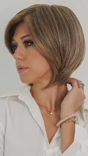 Model is wearing POISED by TRESSALLURE in color 17/23/R8 | Beige Blonde and Auburn Blended with Medium Brown Roots
