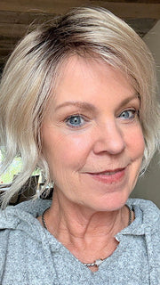 Susan Sparks @an_affair_with_hair wearing DONNA by ENVY in color SILKY BEIGE | Light Platinum Blonde with Dark Brown Root (window lighting)