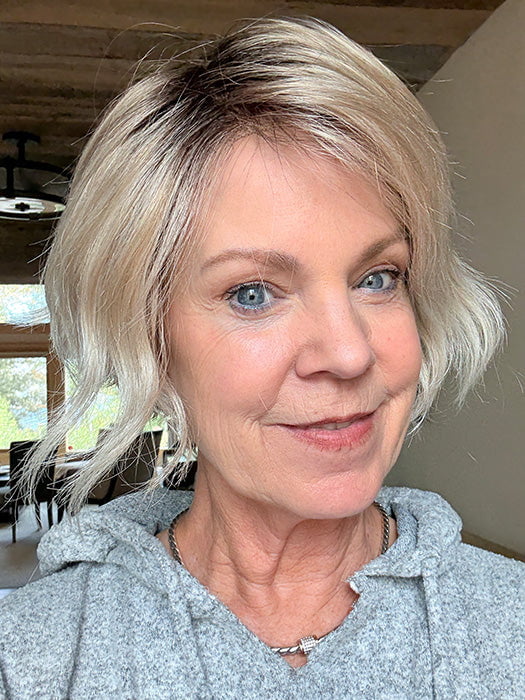 Susan Sparks @an_affair_with_hair wearing DONNA by ENVY in color SILKY BEIGE | Light Platinum Blonde with Dark Brown Root (window lighting)