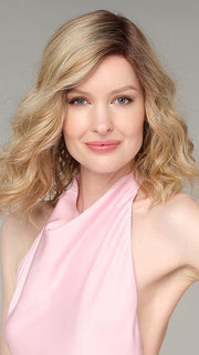 Model wearing EMMA by ENVY in SPARKLING CHAMPAGNE | Medium Brown roots with overall Strawberry Blonde base and soft Golden Blonde highlights