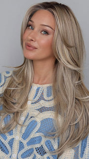 Heather @cjswigs wearing FEATURE LENGTH by RAQUEL WELCH in color RL19/23SS SHADED BISCUIT | Light Ash Blonde Evenly Blended with Cool Platinum Blonde with Dark Roots