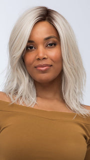 Model is wearing FENIX by ESTETICA in color SILVERSUN/RT8 | Iced Blonde Dusted with Soft Sand and Golden Brown Roots
