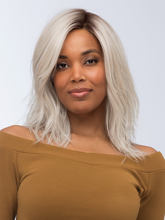 Model is wearing FENIX by ESTETICA in color SILVERSUN/RT8 | Iced Blonde Dusted with Soft Sand and Golden Brown Roots