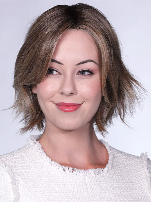 Model is wearing FERRARI By BELLETRESS in color SUNKISSED ALMOND R | A blend of Medium and Light Brown with Light Gold Blonde Highlights and a hint of Cooler Blonde, rooted with Medium and Light Brown